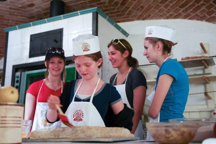 Young passengers learn to make Viennese strudel onboard a Tauck ship as they cruise through Austria.